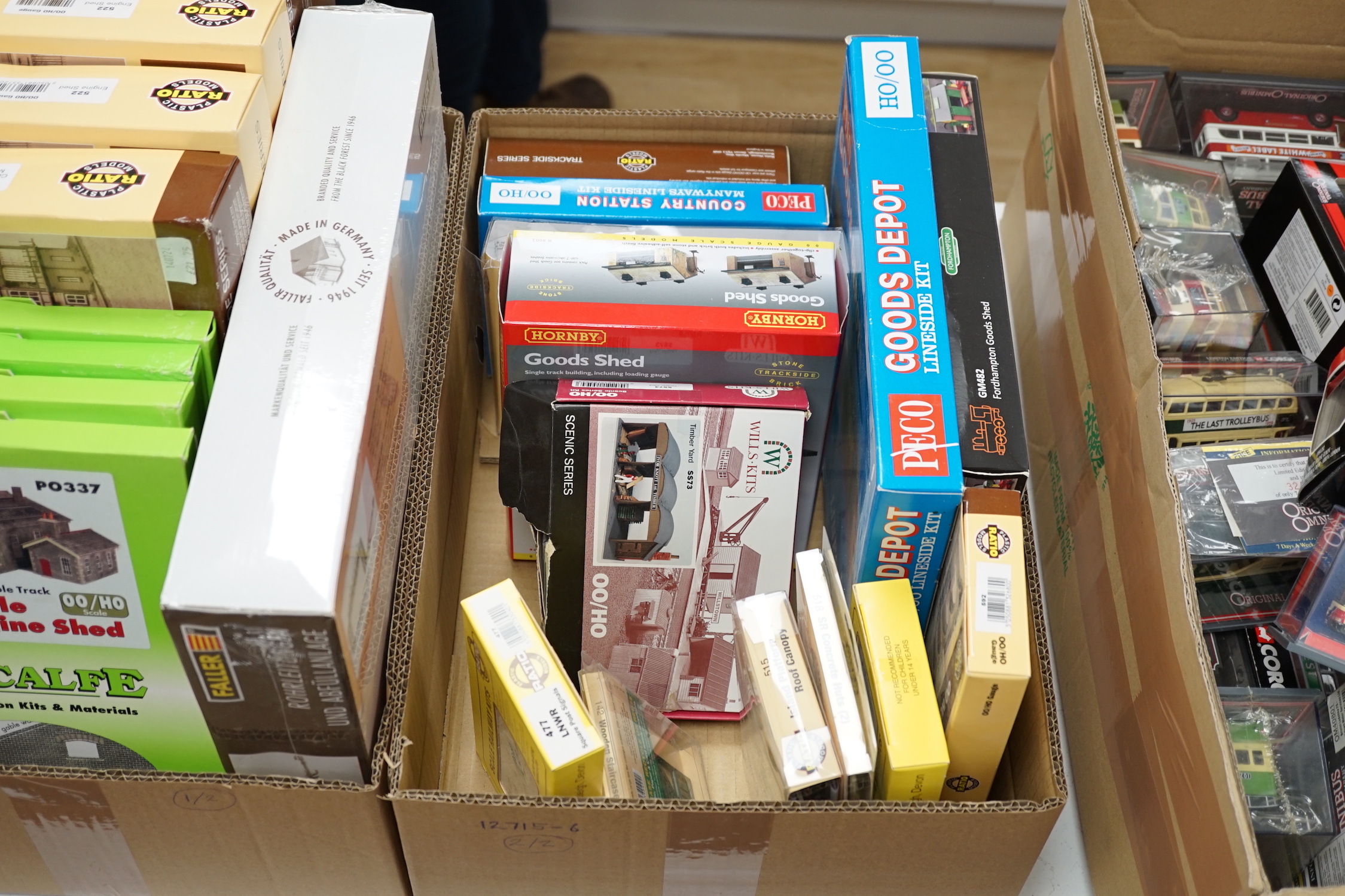 A collection of boxed and unconstructed 00 and HO Gauge model railway kits and trackside accessories, by Ratio, Metcalfe, Peco, Springside Models, etc. including; goods sheds, engine sheds, station buildings, signals, et